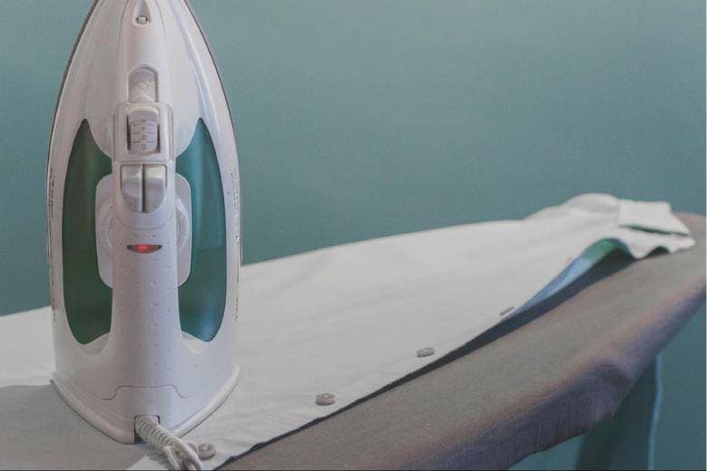 Steam iron on an ironing board